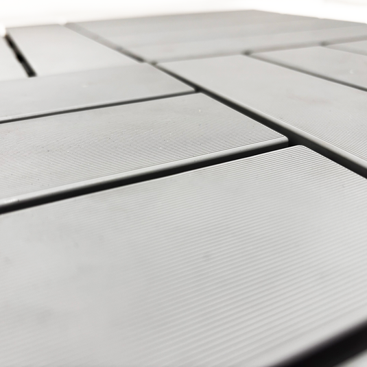 Close-up of gray decking tiles with a grid pattern